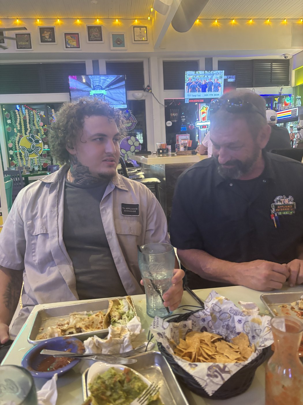 Two TN Appliance Exchange technicians in branded shirts